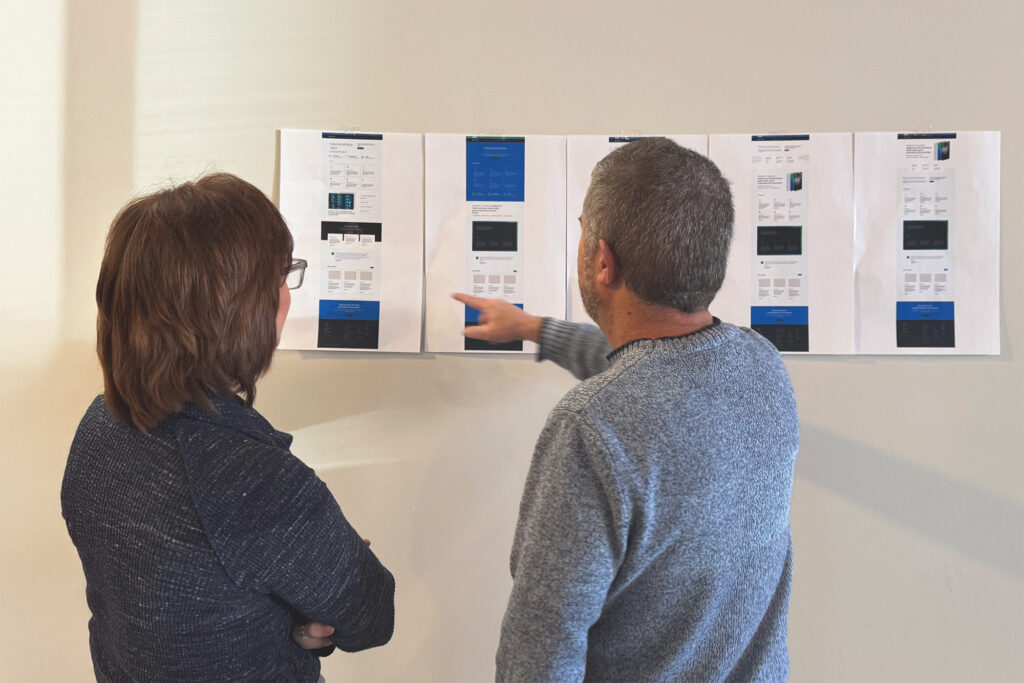Team members discuss early iterations of the Secure Data Technologies website